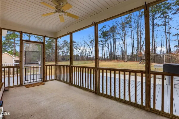 a view of an empty room with a ceiling fan