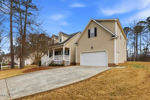 a front view of a house with a yard and garage