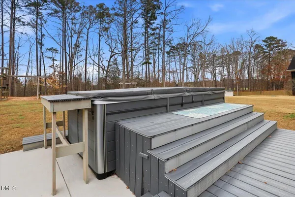 a roof deck with table and chairs and wooden floor