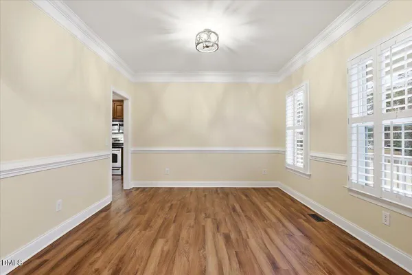a picture of a room with a white wall and a large window