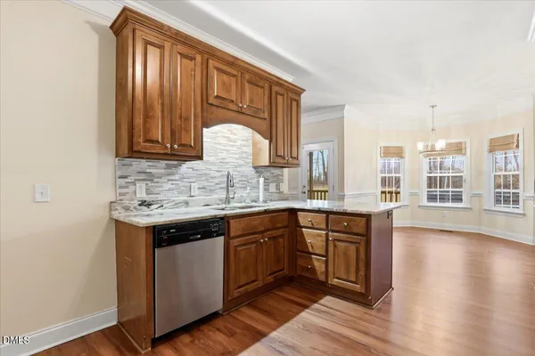 a view of a room with wooden floor and windows