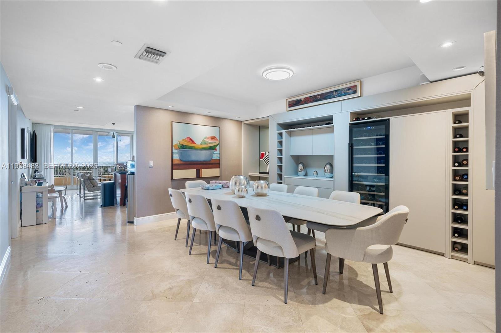 799 Crandon Boulevard, Unit 908 Key Biscayne, FL 33149 - Photo 13 of 30 a dining room with furniture a rug and chandelier