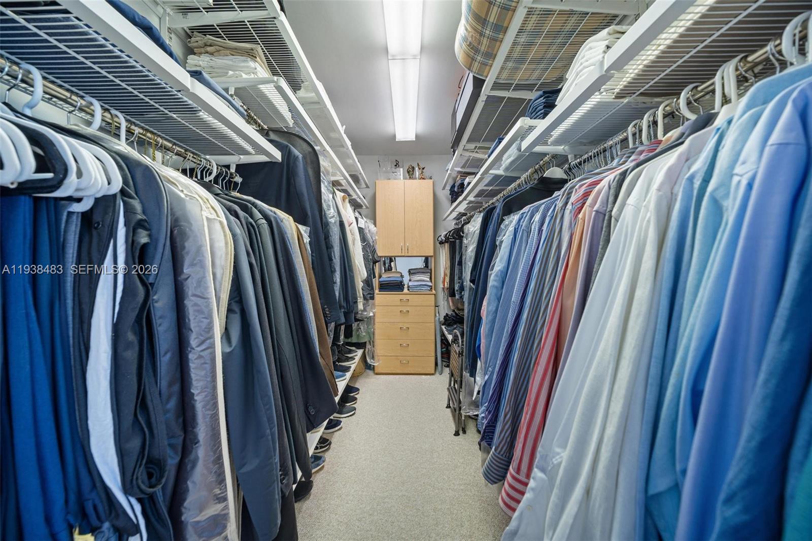 799 Crandon Boulevard, Unit 908 Key Biscayne, FL 33149 - Photo 21 of 30 a view of walk in closet with clothes and shoes