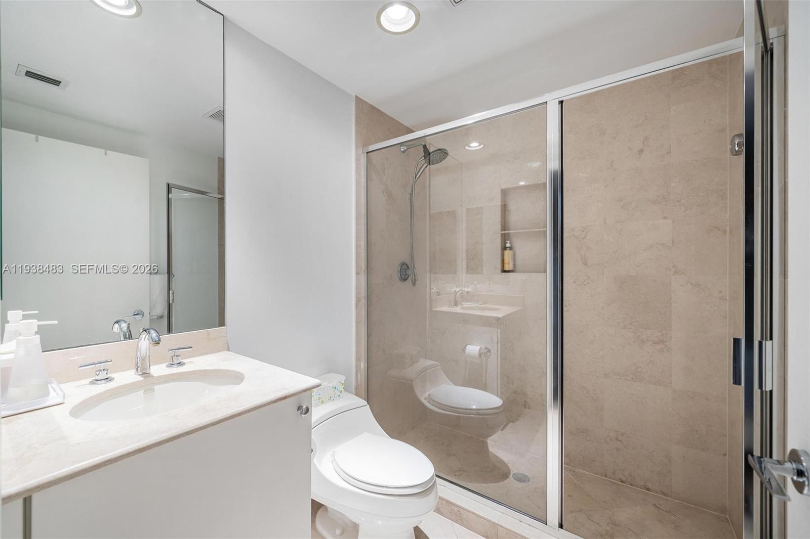 799 Crandon Boulevard, Unit 908 Key Biscayne, FL 33149 - Photo 26 of 30 a bathroom with a sink a toilet and shower