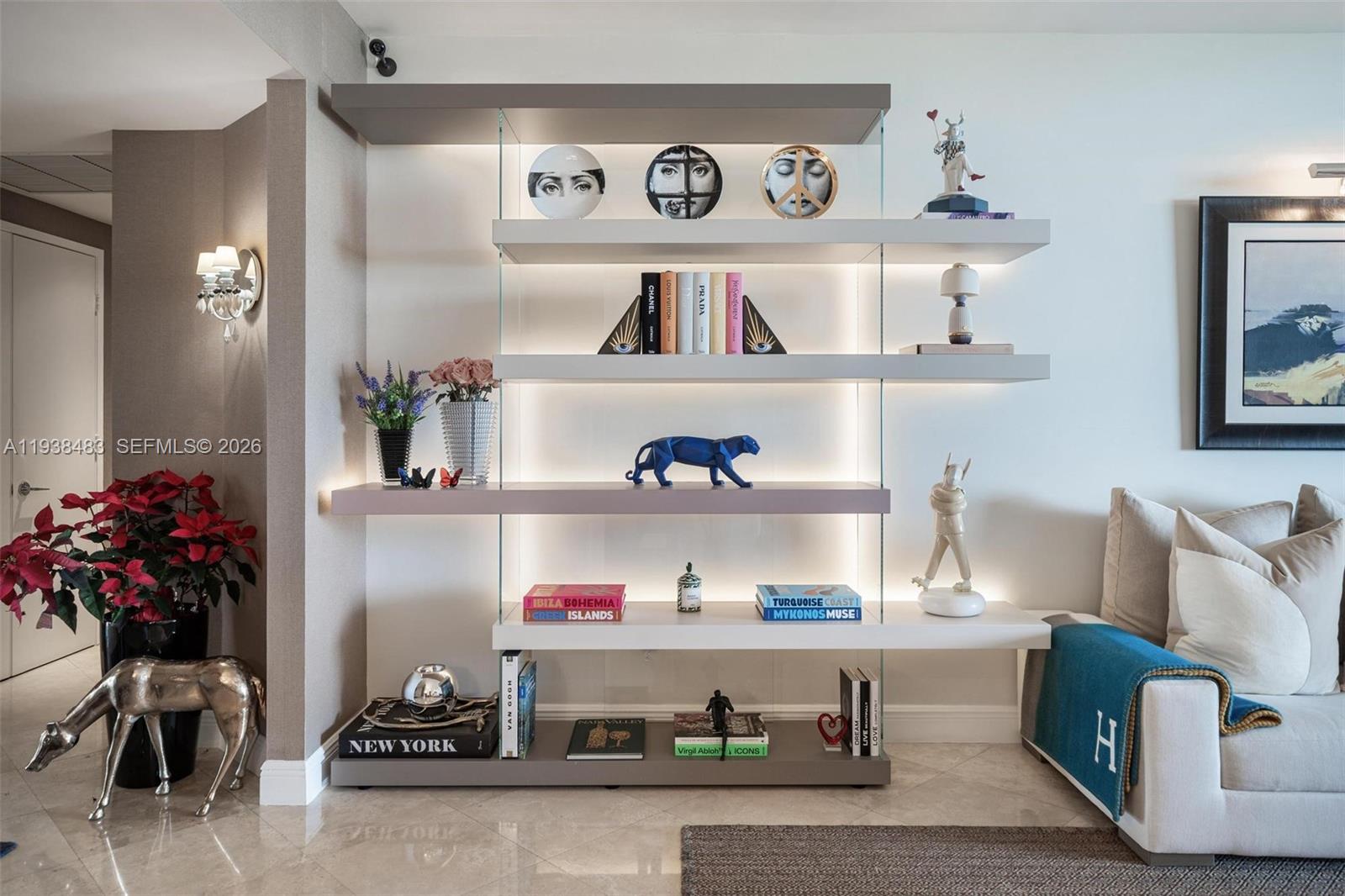 799 Crandon Boulevard, Unit 908 Key Biscayne, FL 33149 - Photo 3 of 30 a room with a book shelf and a couch