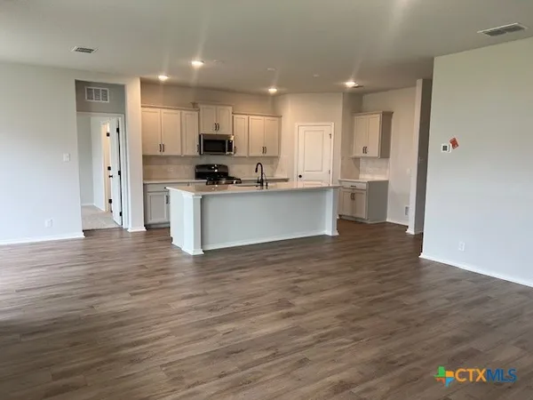 a stove top oven sitting inside of a kitchen