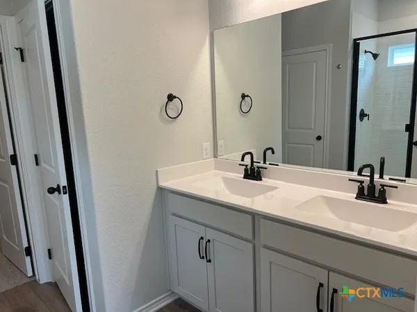 a kitchen with a sink and wooden floor