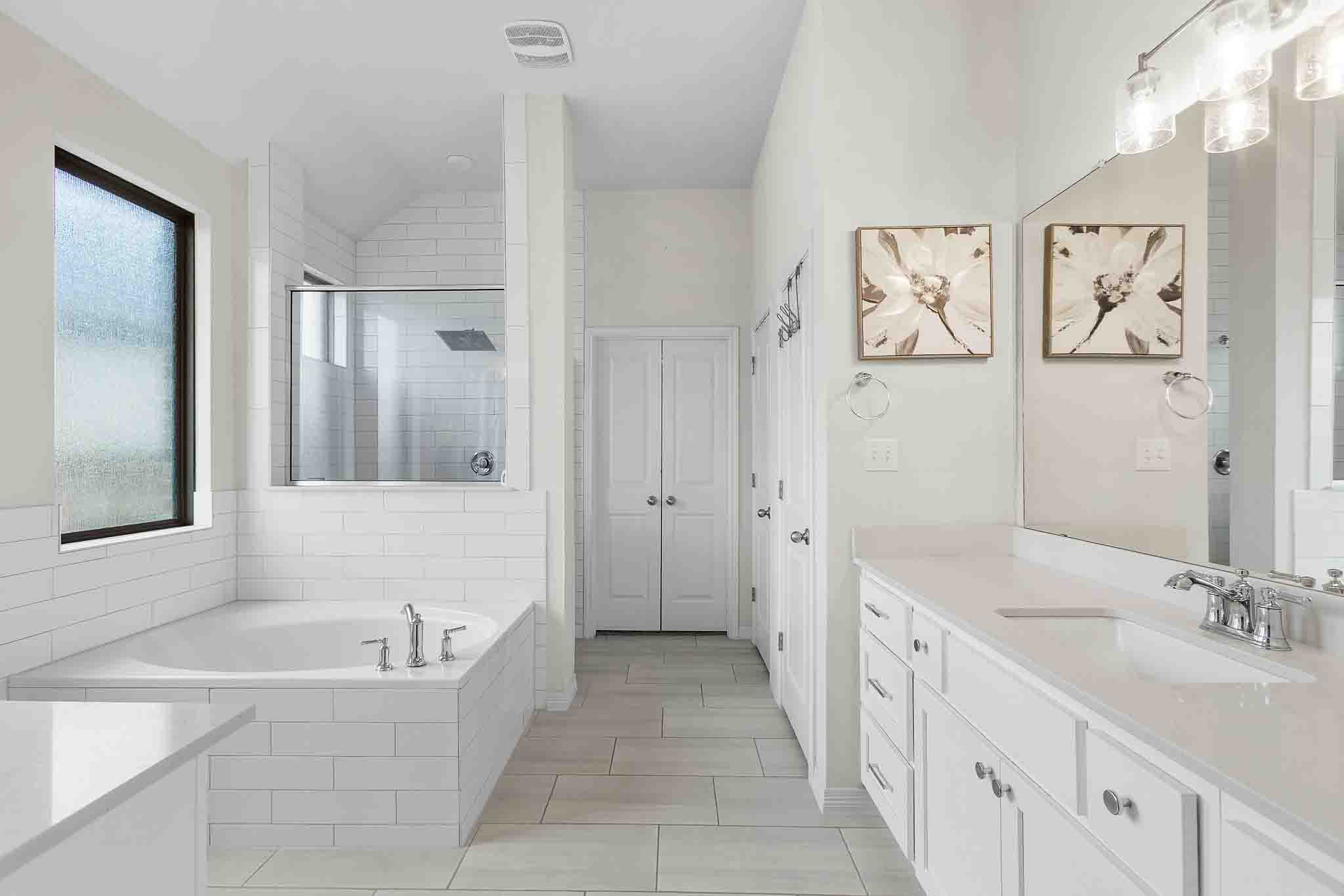 166 West Branch Road Kyle, TX 78640 - Photo 16 of 39 Indulge in a tranquil retreat with a spacious soaking tub and a dedicated walk-in shower.
