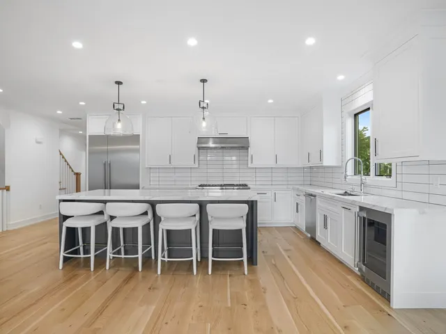 a large kitchen with a table and chairs