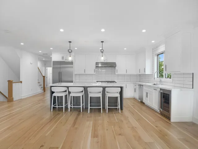 a kitchen with a stove sink and cabinets