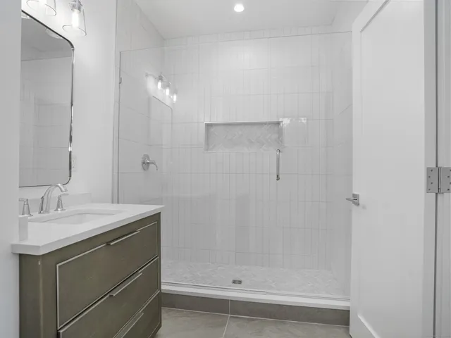 a bathroom with a sink a toilet and a mirror