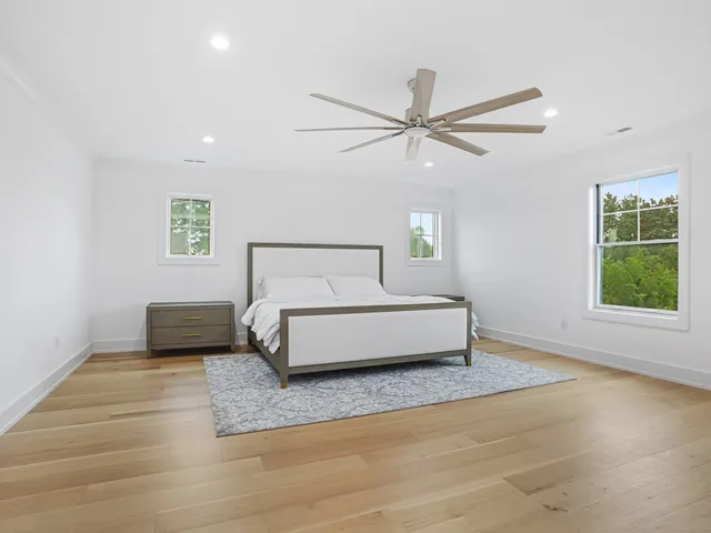 a bedroom with a bed and a ceiling fan