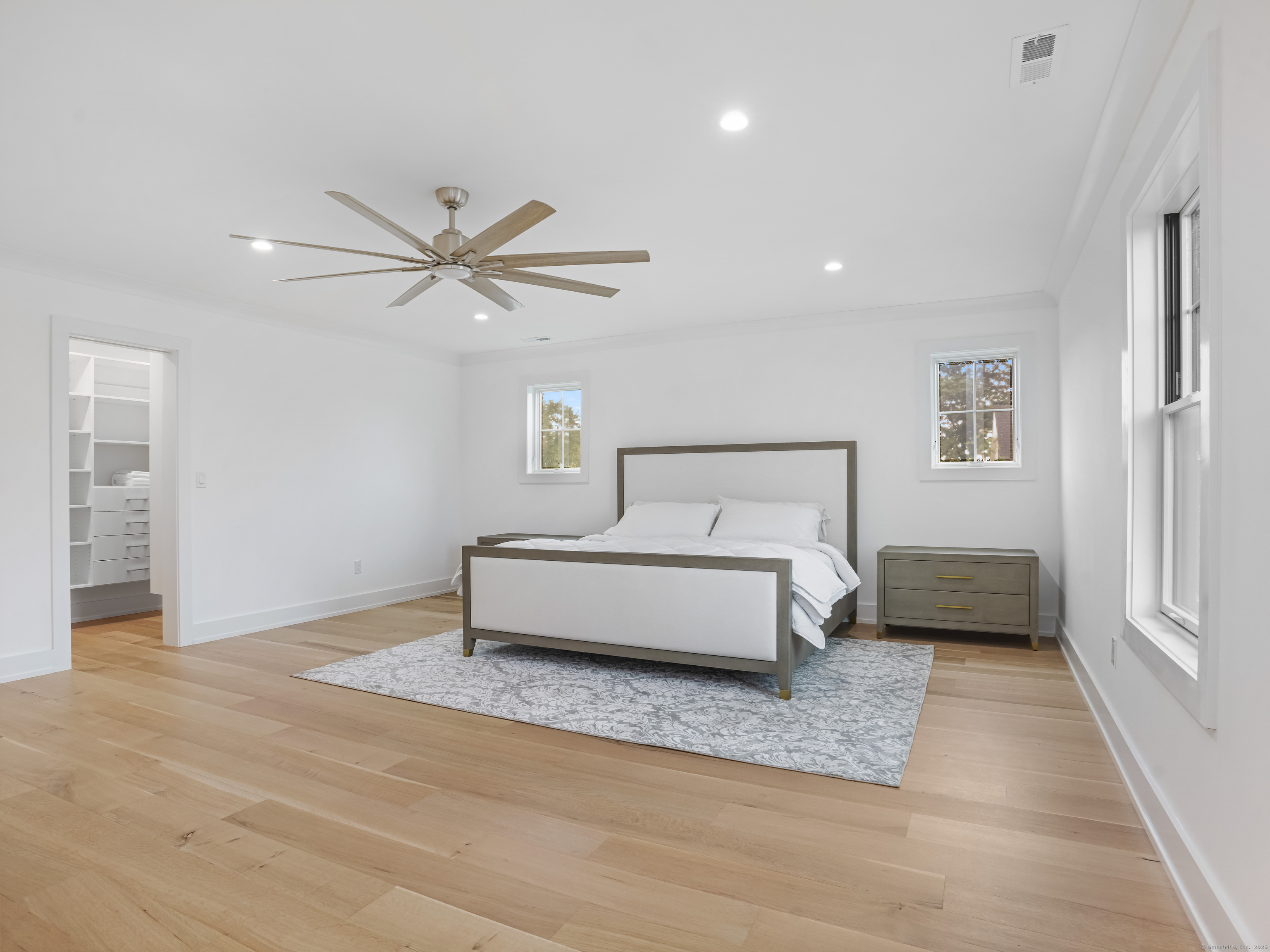 345 Reef Road, Unit C9 Fairfield, CT 06824 - Photo 33 of 39 a bedroom with a bed and a ceiling fan