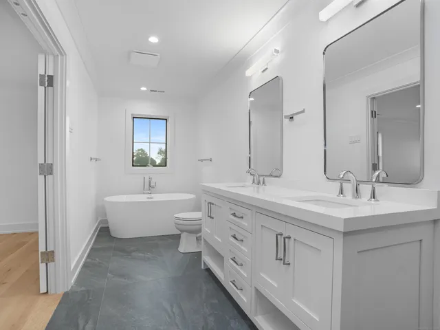 a bathroom with double sink and a mirror
