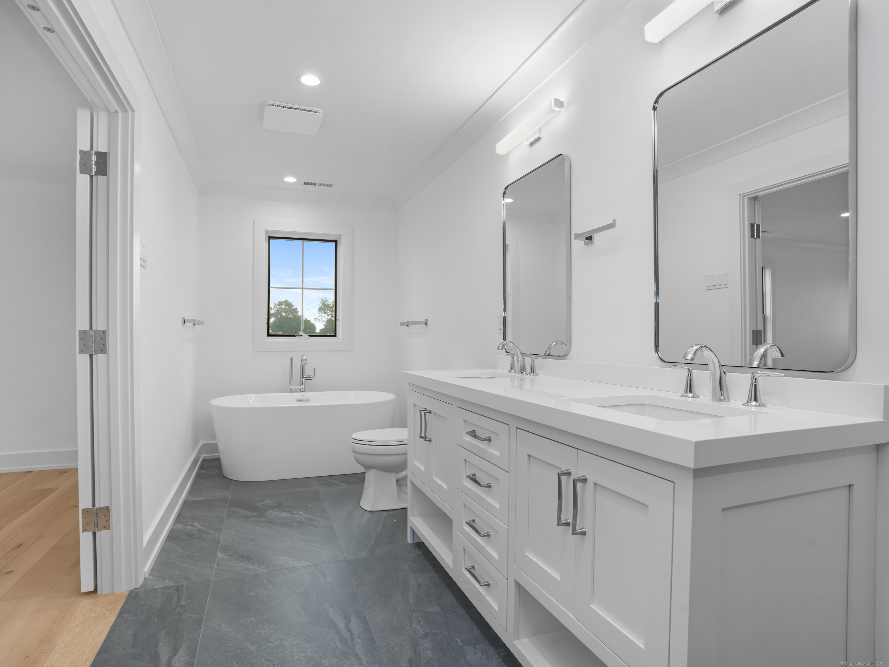 345 Reef Road, Unit C9 Fairfield, CT 06824 - Photo 37 of 39 a spacious bathroom with double vanity a mirror a bathtub and a shower