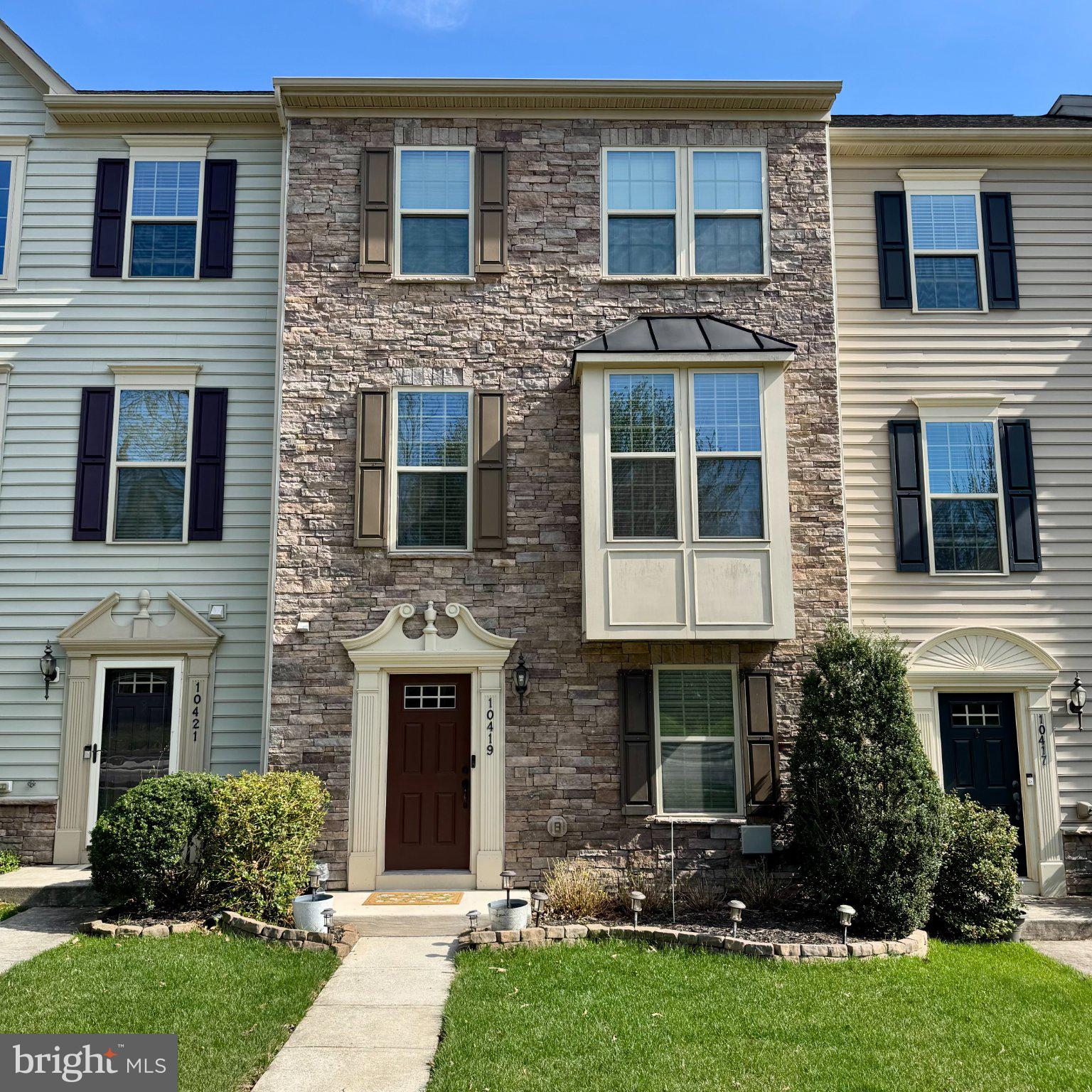 Charming townhouse with stone accents.