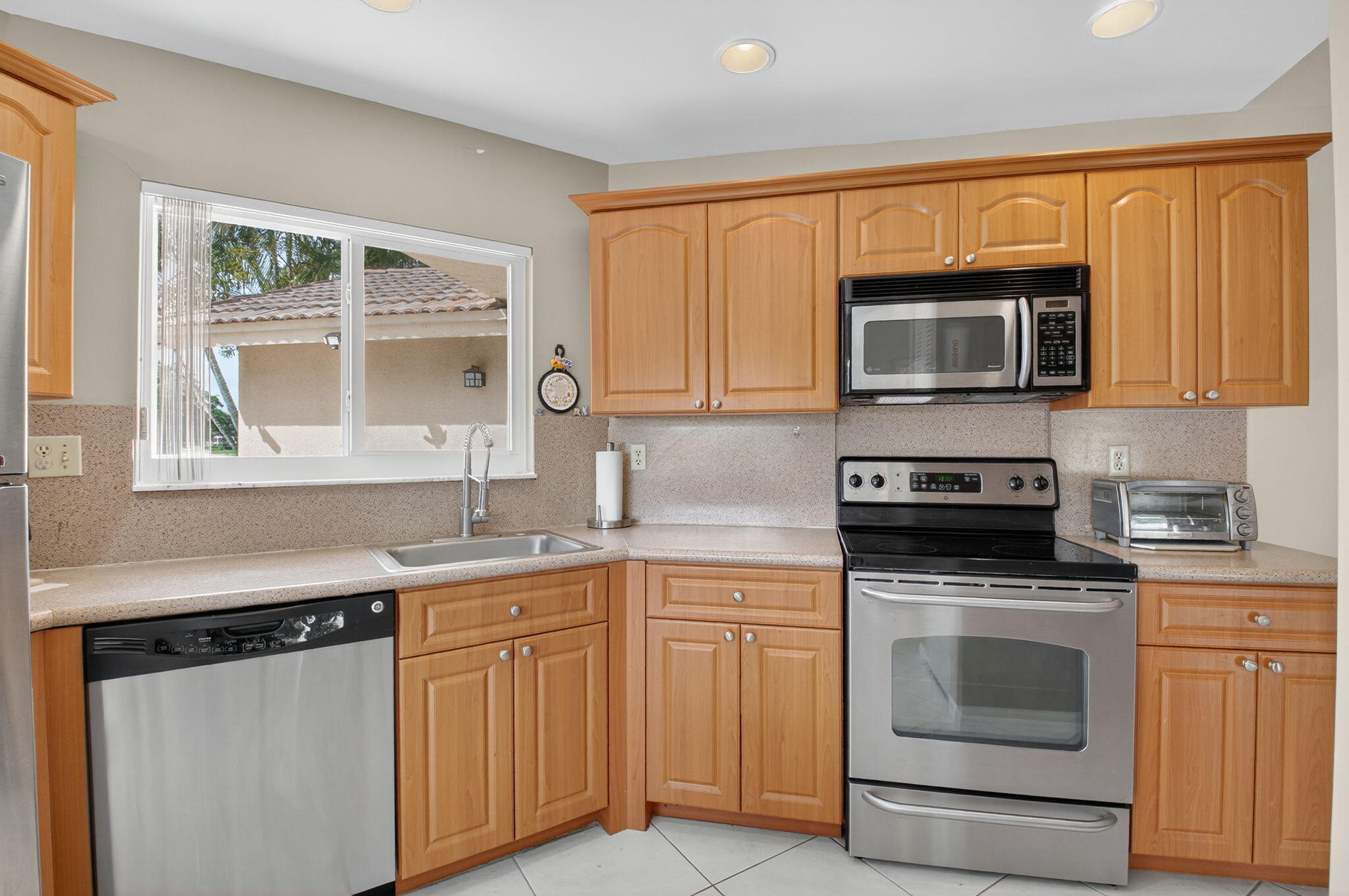 6290 Sweet Maple Lane Boca Raton, FL 33433 - Photo 11 of 35 a kitchen with granite countertop a stove sink and microwave