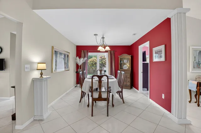a view of a dining room with furniture and chandelier