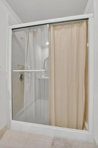 a bathroom with a shower and a window