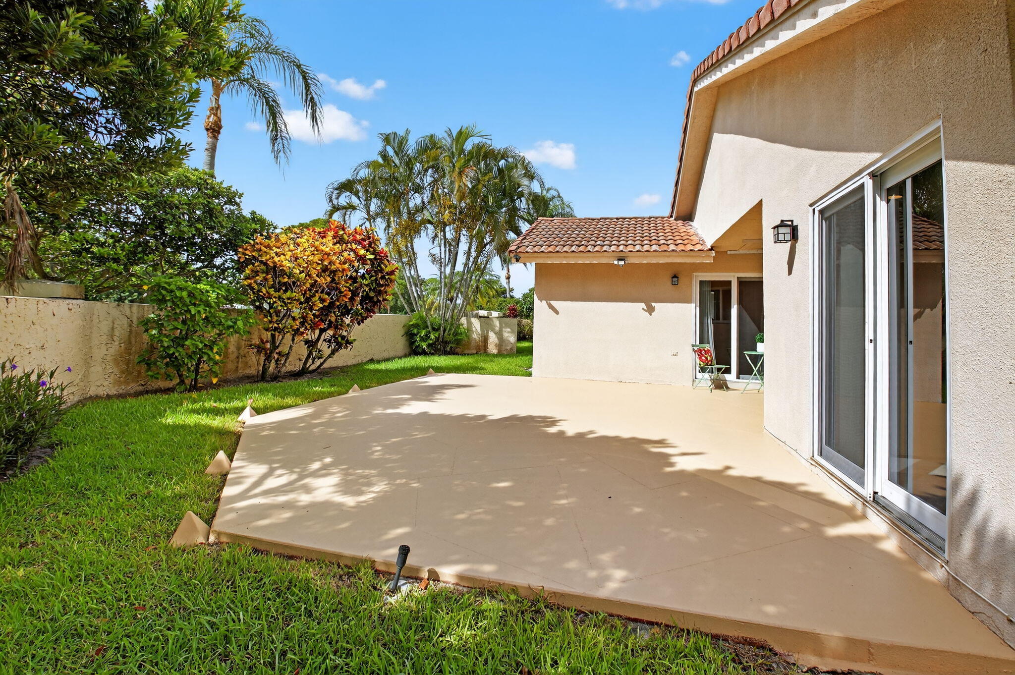 6290 Sweet Maple Lane Boca Raton, FL 33433 - Photo 28 of 35 a view of a white house with a yard plants and large tree
