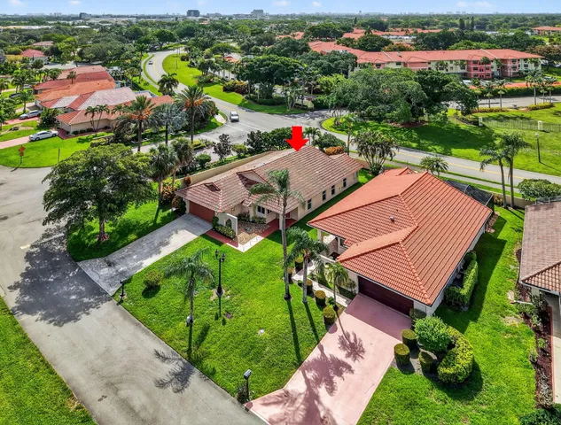 an aerial view of a house with a garden and swimming pool