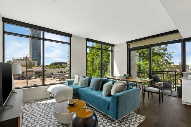 a living room with furniture and a floor to ceiling window