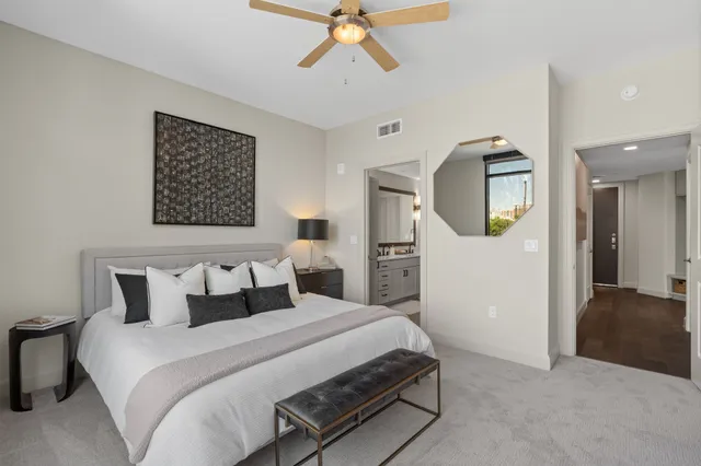 a bedroom with a bed and a chandelier