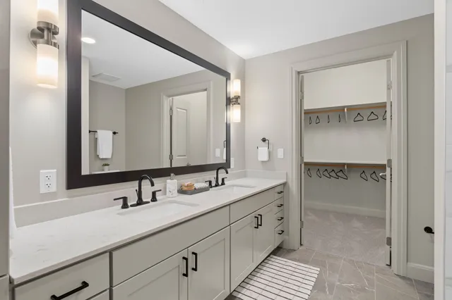 a bathroom with a double vanity sink and mirror