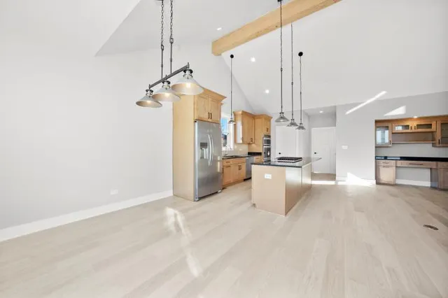 a view of a kitchen with kitchen appliances and a window