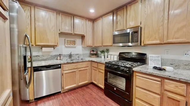 a kitchen with stainless steel appliances a stove and a refrigerator