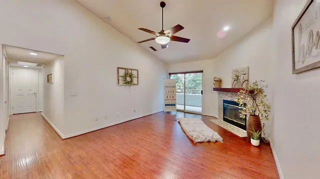 a kitchen with stainless steel appliances a refrigerator and wooden floor