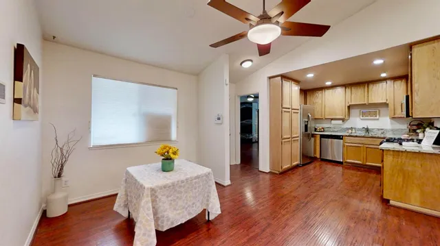 wooden floor fireplace and windows in an empty room