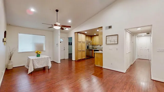 a view of an empty room with wooden floor