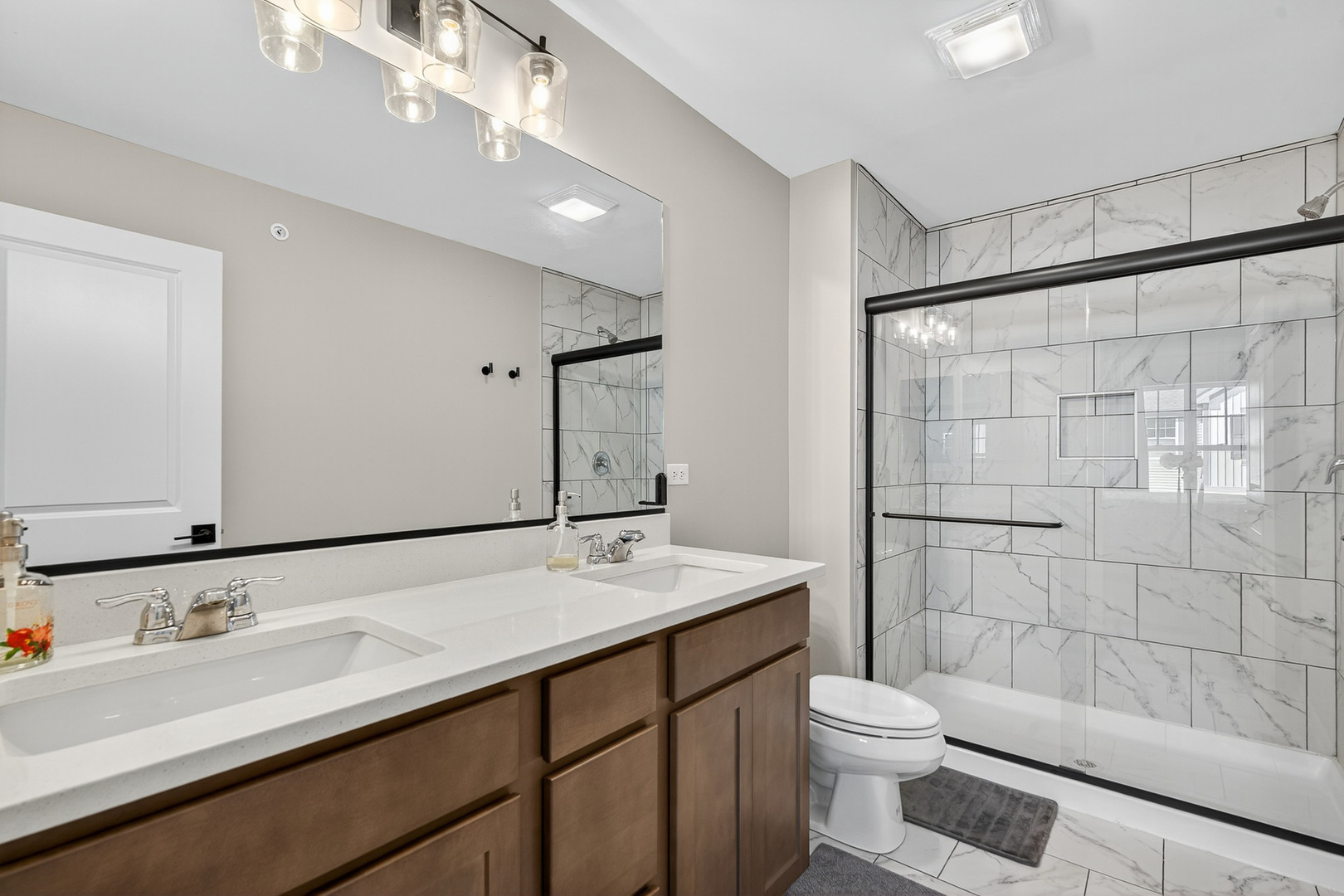 30-w136 Wheeler Circle Aurora, IL 60502 - Photo 13 of 23 a bathroom with a sink a toilet and shower