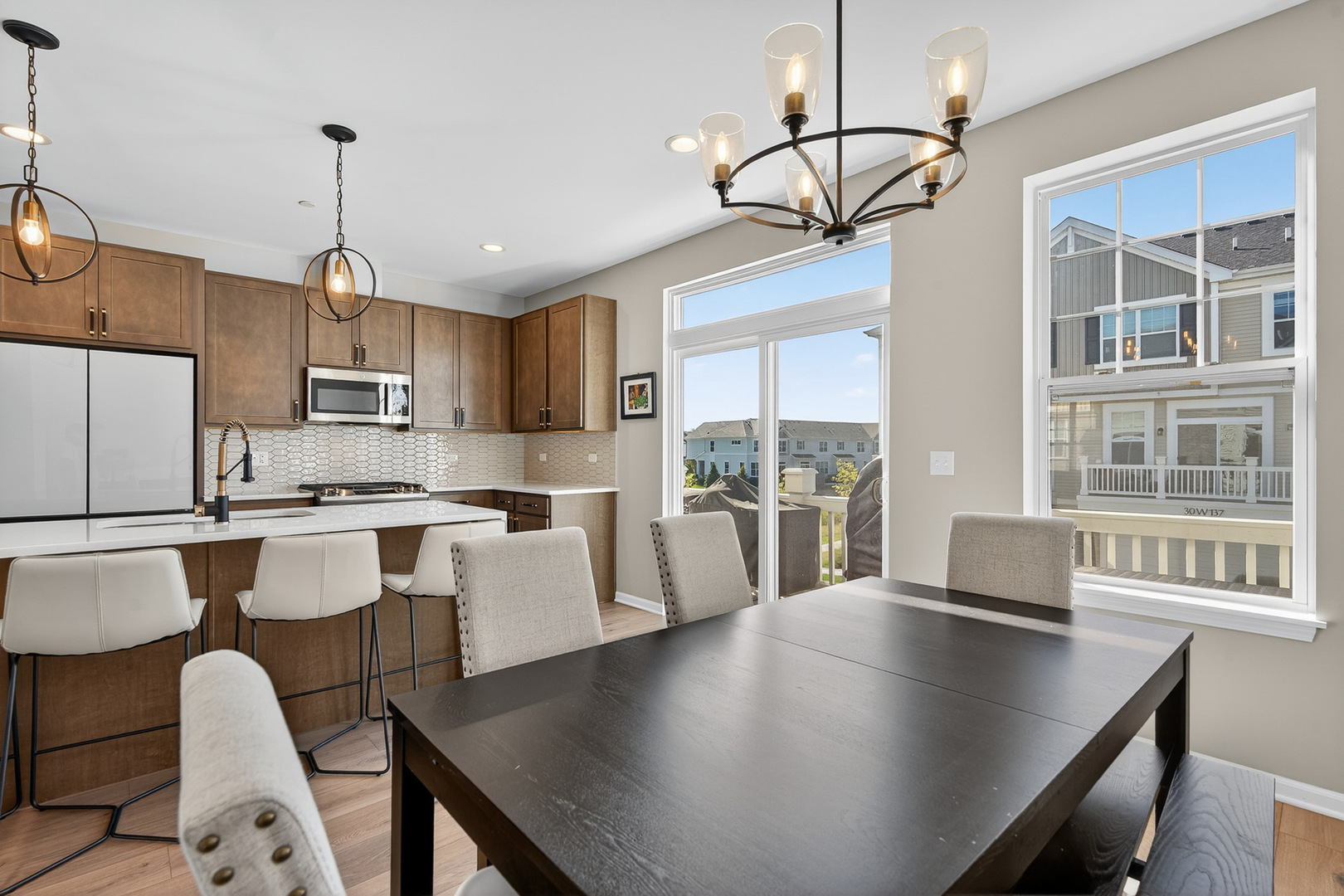 30-w136 Wheeler Circle Aurora, IL 60502 - Photo 9 of 23 a view of kitchen with dining table chairs and wooden floor