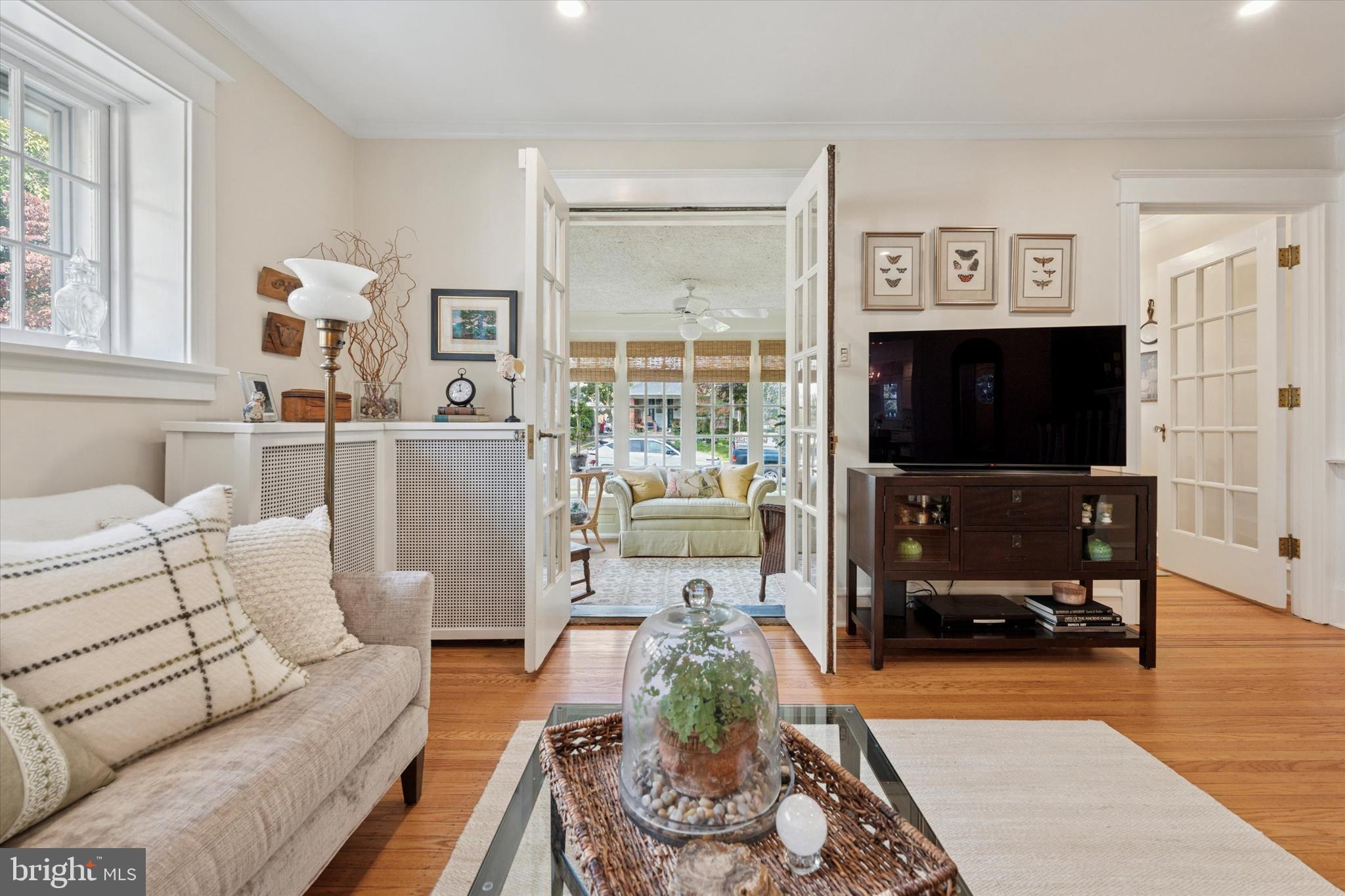 2918 Rising Sun Road Ardmore, PA 19003 - Photo 7 of 33 a living room with furniture a flat screen tv and a floor to ceiling window