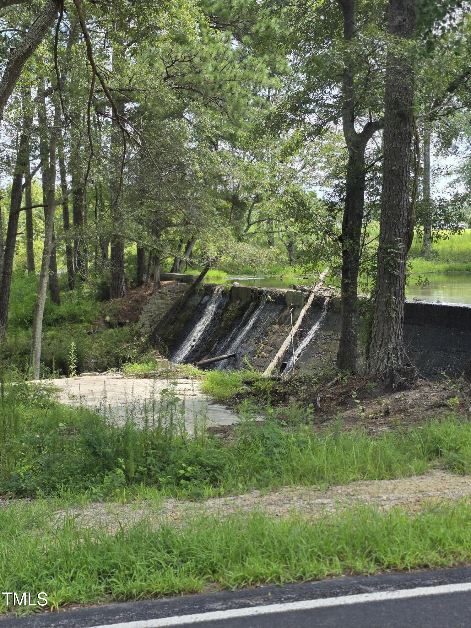 0 Dukes Lake Road Zebulon, NC 27597 - Photo 4 of 11 a backyard of a house with yard and outdoor seating