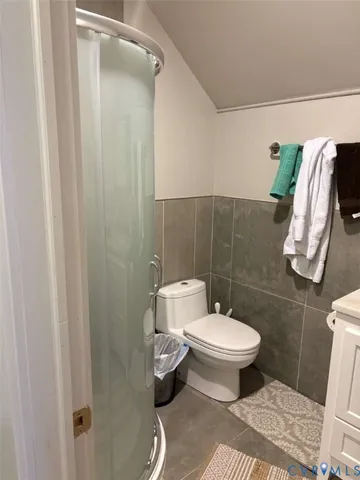 a bedroom with a bed and a chair