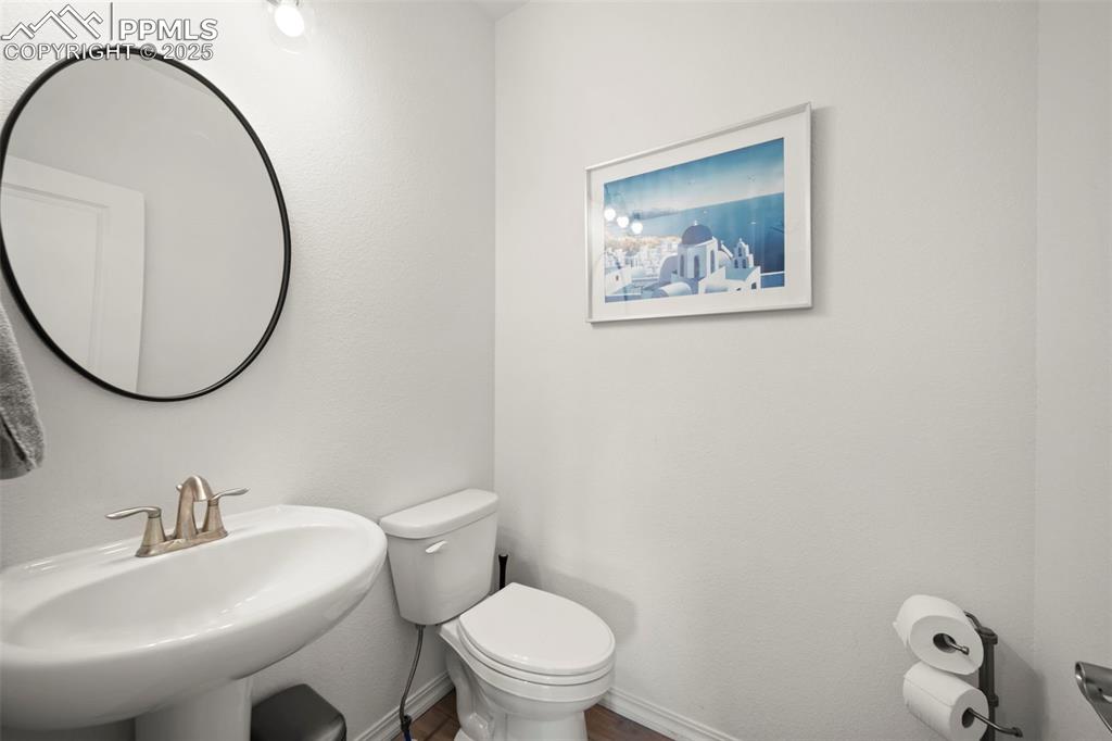 4661 Horse Gulch Loop Colorado Springs, CO 80924 - Photo 15 of 48 a bathroom with a toilet a sink and a mirror