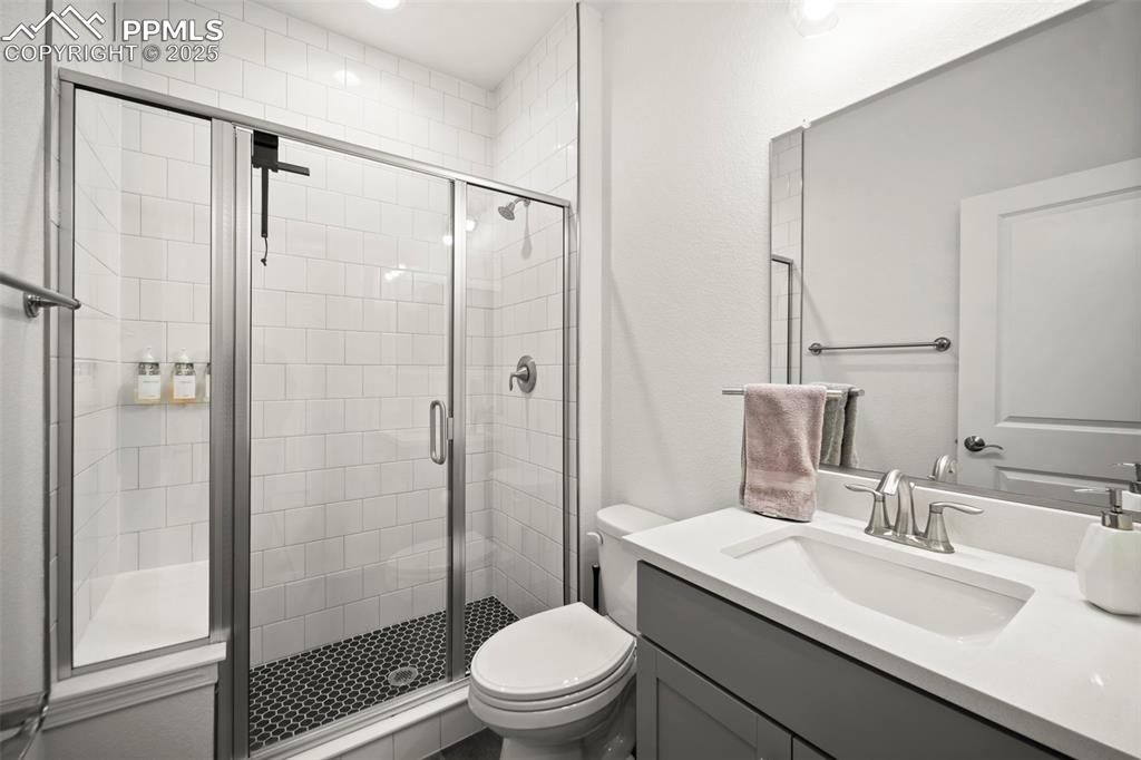 4661 Horse Gulch Loop Colorado Springs, CO 80924 - Photo 17 of 48 a bathroom with a sink toilet and shower