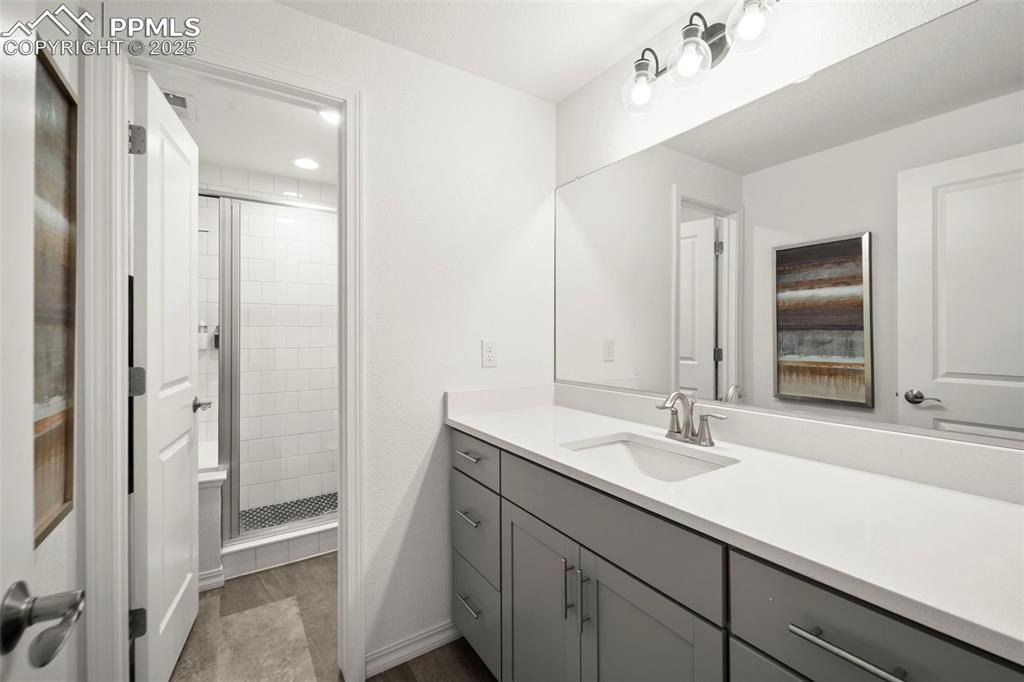 4661 Horse Gulch Loop Colorado Springs, CO 80924 - Photo 25 of 48 a bathroom with a sink double vanity and a mirror