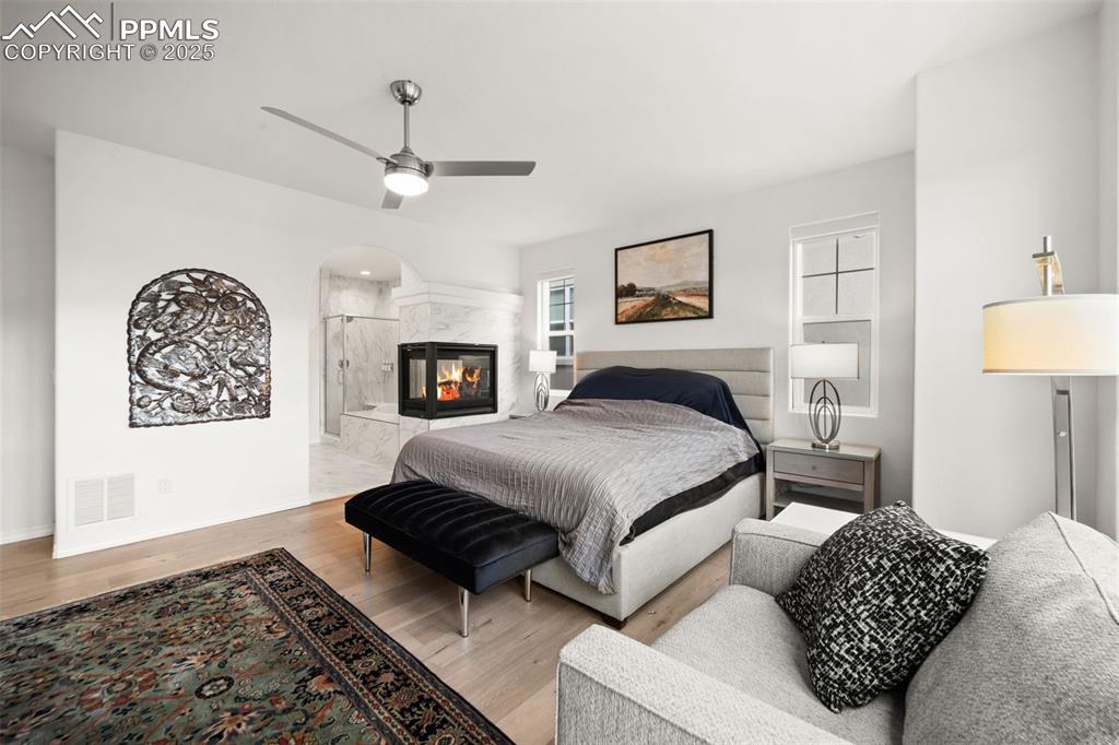 4661 Horse Gulch Loop Colorado Springs, CO 80924 - Photo 32 of 48 a bedroom with a bed and a lamp