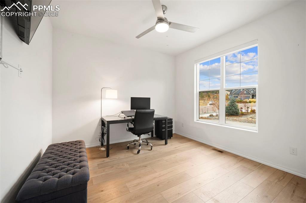 4661 Horse Gulch Loop Colorado Springs, CO 80924 - Photo 36 of 48 a view of a workspace with furniture and a window