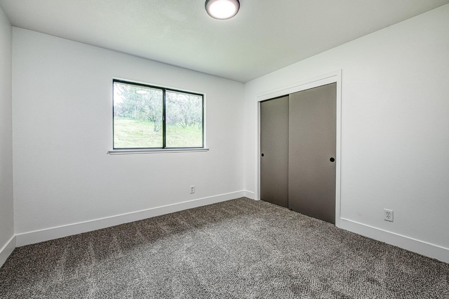 42741 Revis Way Coarsegold, CA 93614 - Photo 11 of 17 an empty room with windows and closet