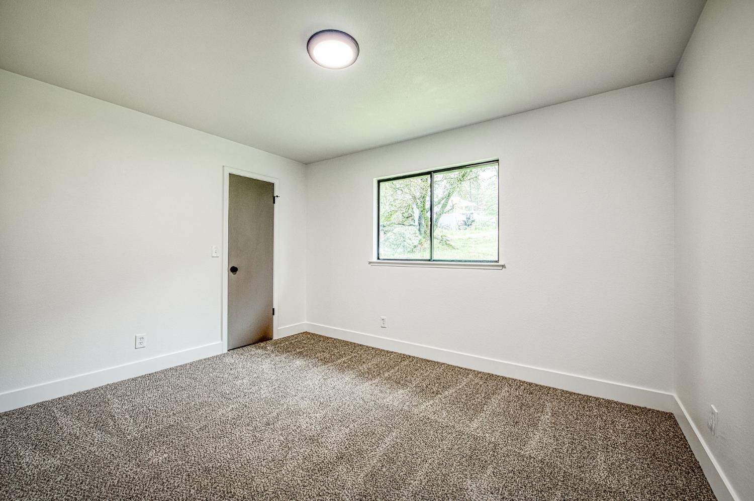 42741 Revis Way Coarsegold, CA 93614 - Photo 13 of 17 an empty room with windows