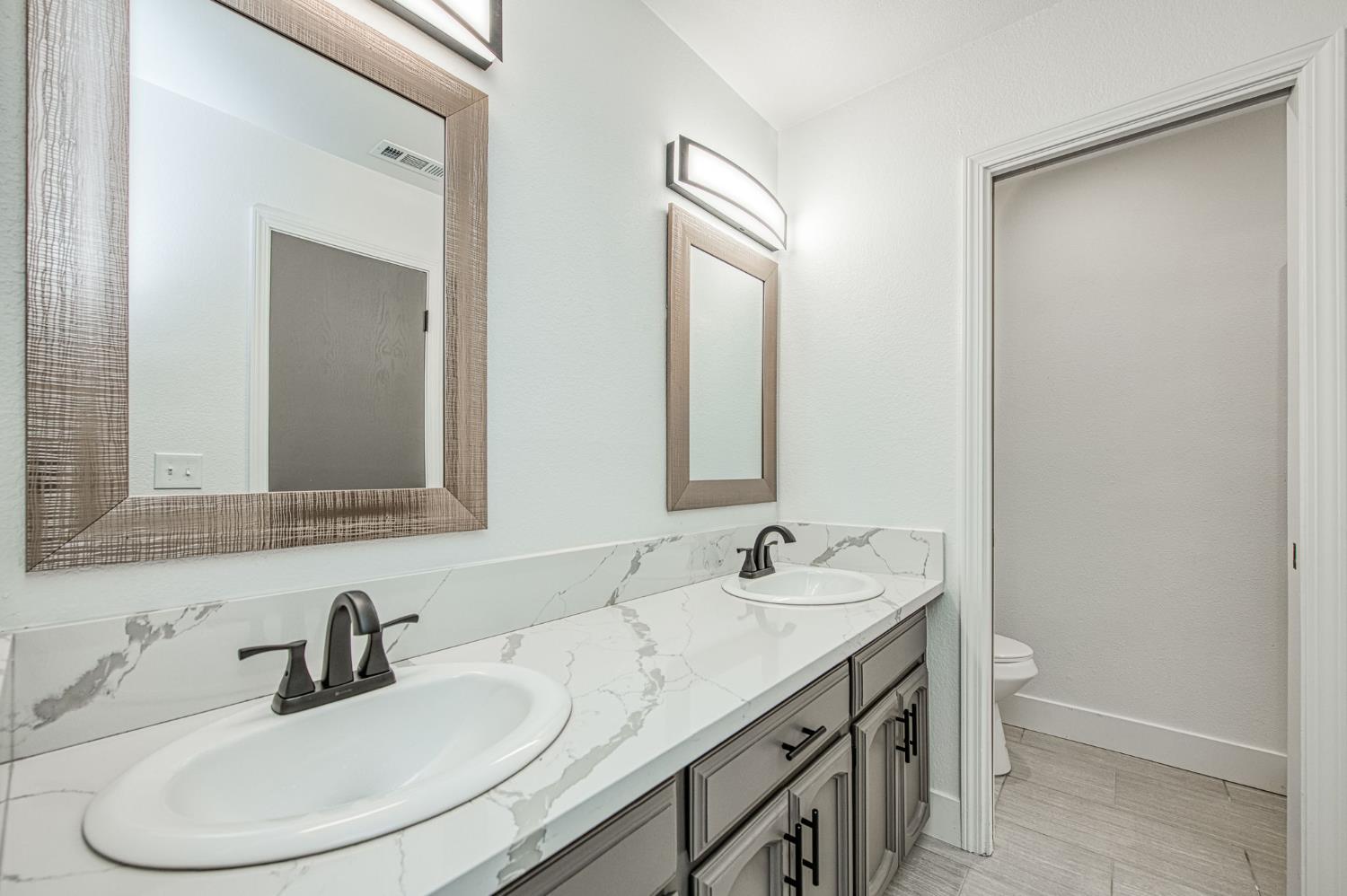 42741 Revis Way Coarsegold, CA 93614 - Photo 16 of 17 a bathroom with a sink and a mirror