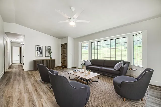 a living room with furniture and a large window