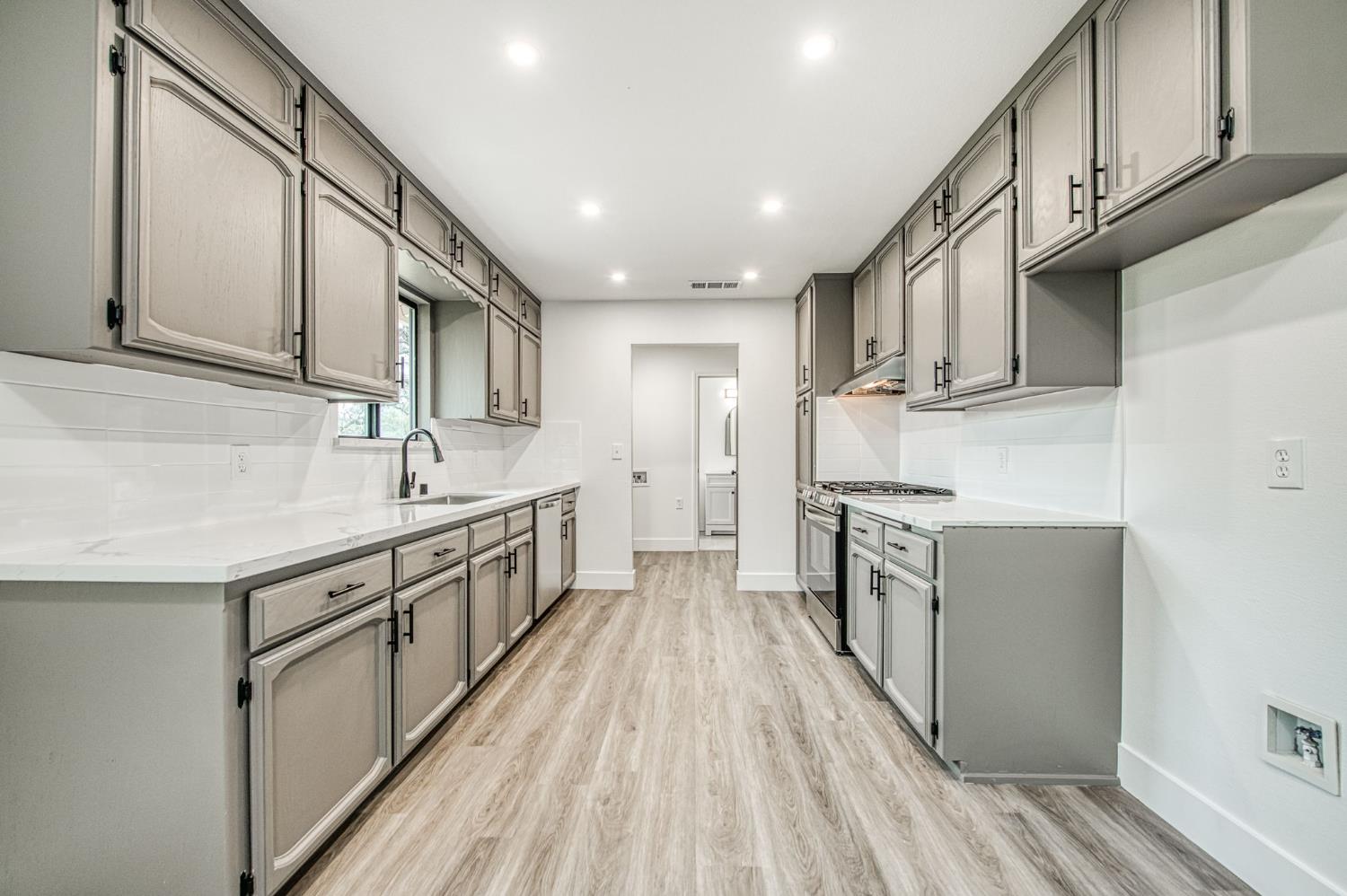 42741 Revis Way Coarsegold, CA 93614 - Photo 6 of 17 a large kitchen with stainless steel appliances granite countertop a lot of counter space and wooden floors