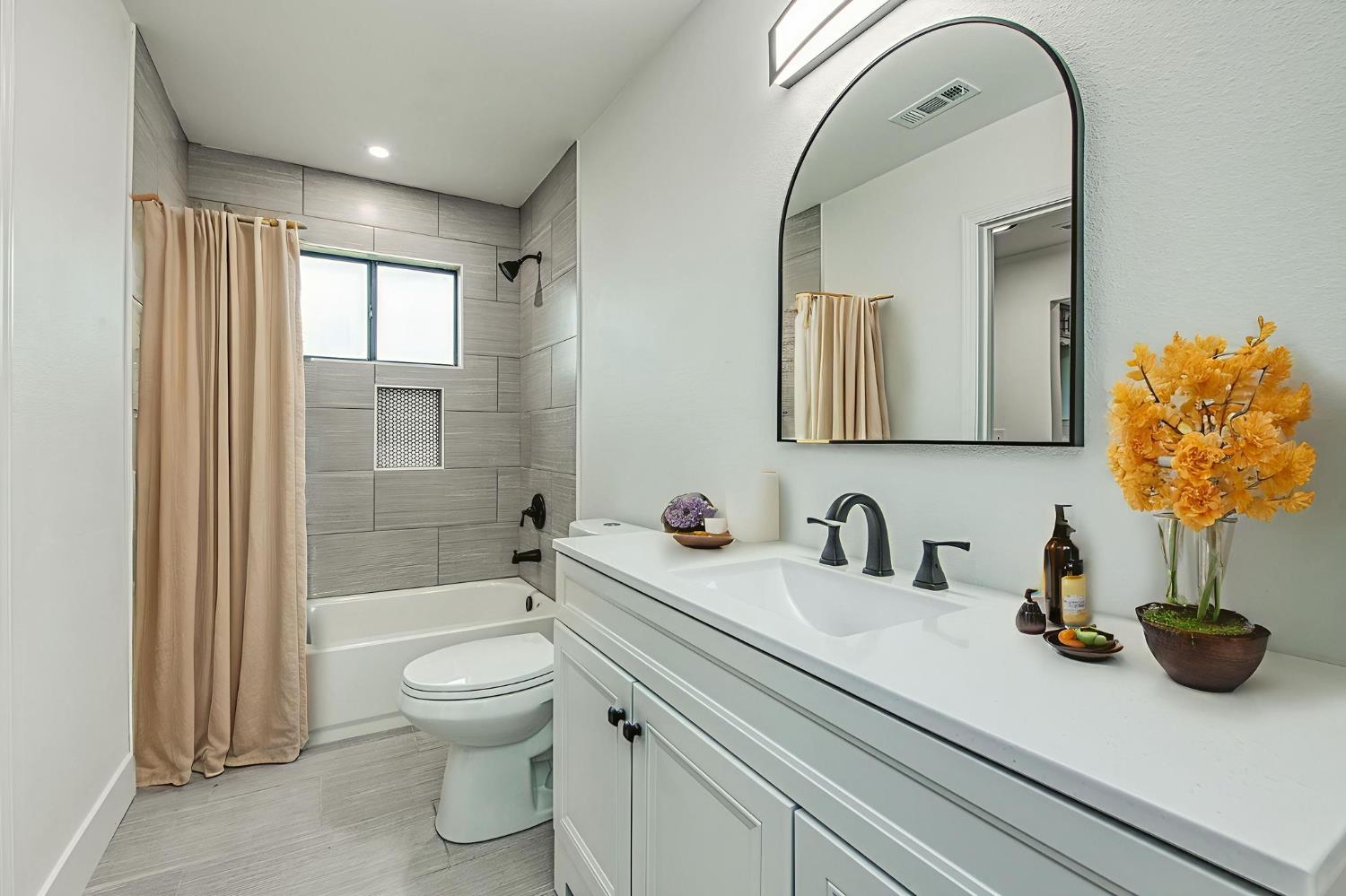 42741 Revis Way Coarsegold, CA 93614 - Photo 10 of 17 a bathroom with a toilet a sink and mirror