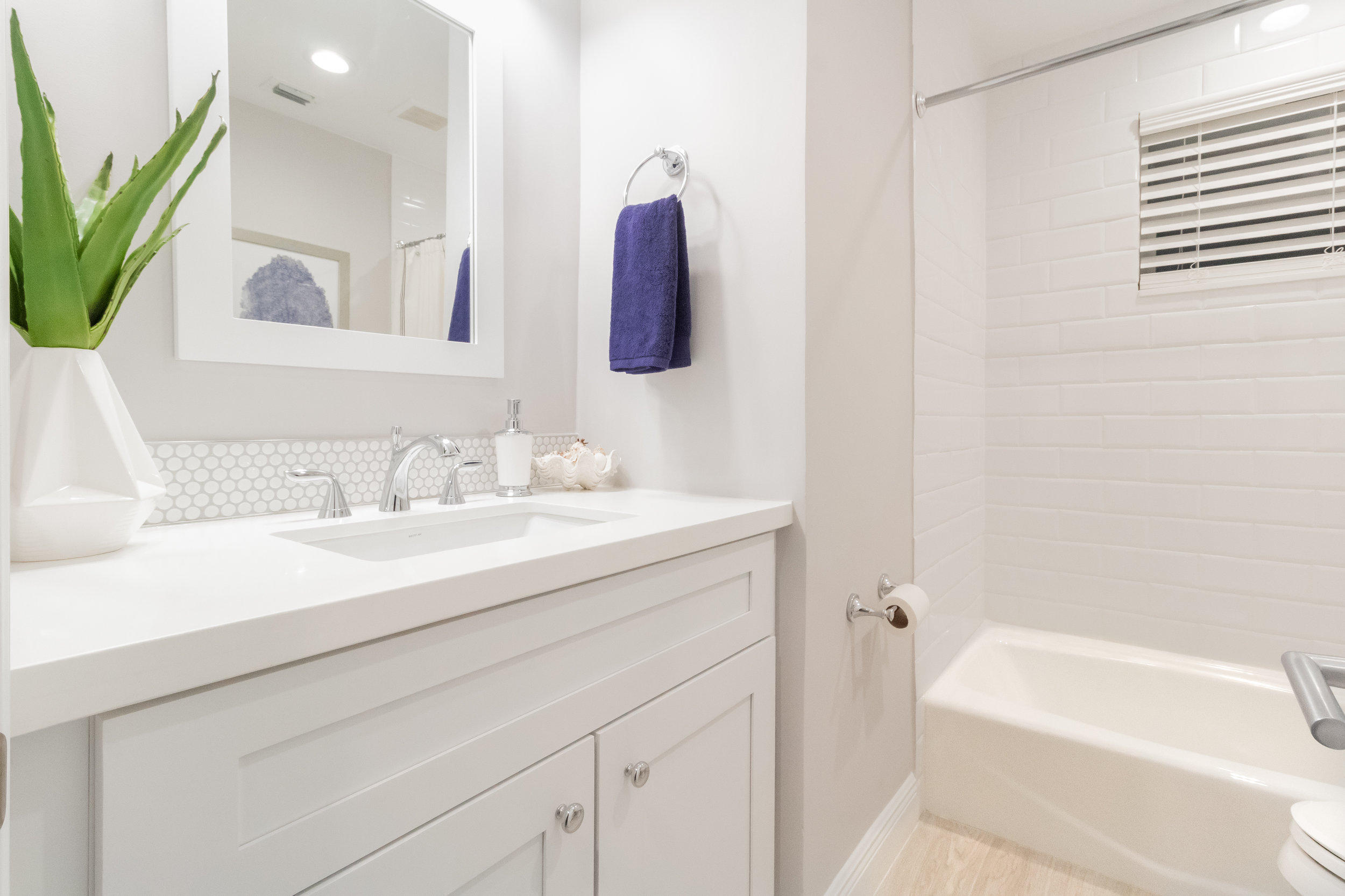 1241 Southwest 8th Street Boca Raton, FL 33486 - Photo 16 of 22 a bathroom with a tub sink and mirror